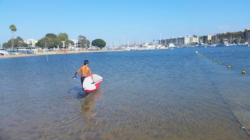 how to get on a paddle board at the beach